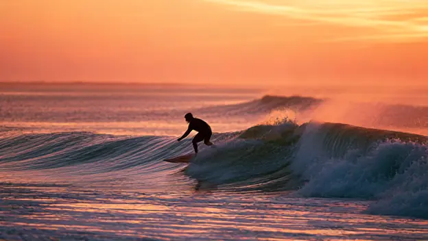 A surfer at dawn
